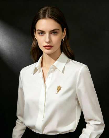 Amber Bloom pearl bouquet brooch worn on white shirt