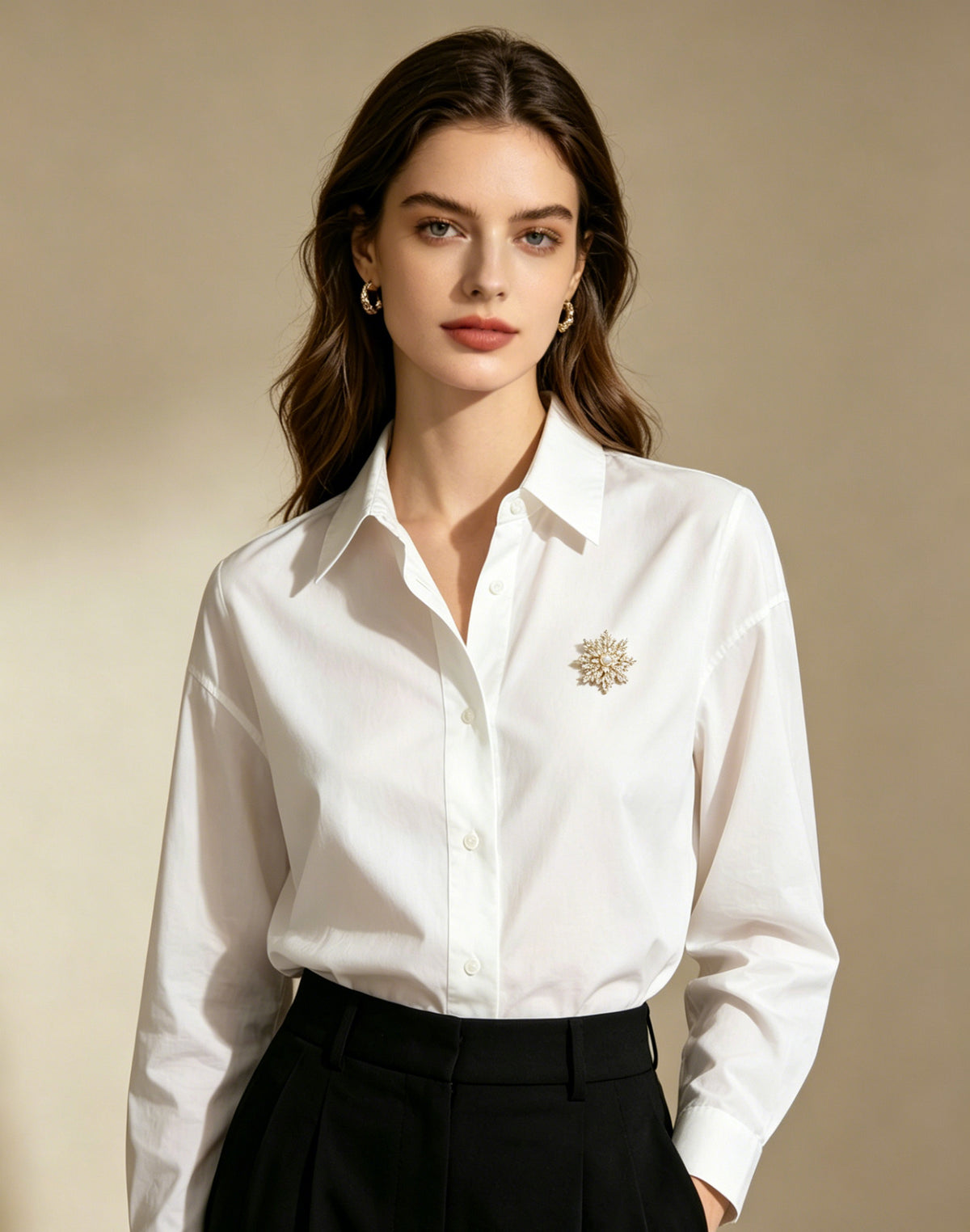 Estrella pearl starburst brooch worn on white shirt