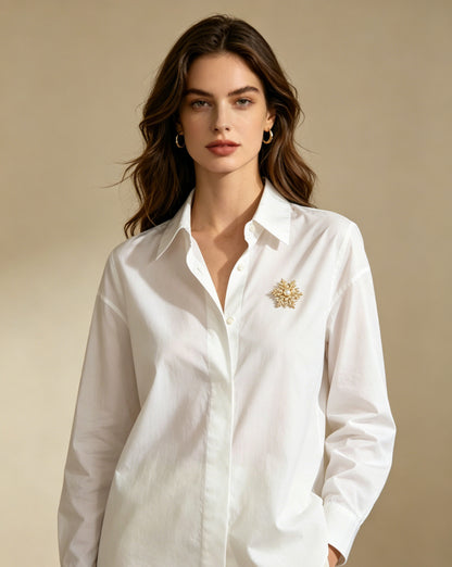 Nivale pearl snowflake brooch worn on white shirt