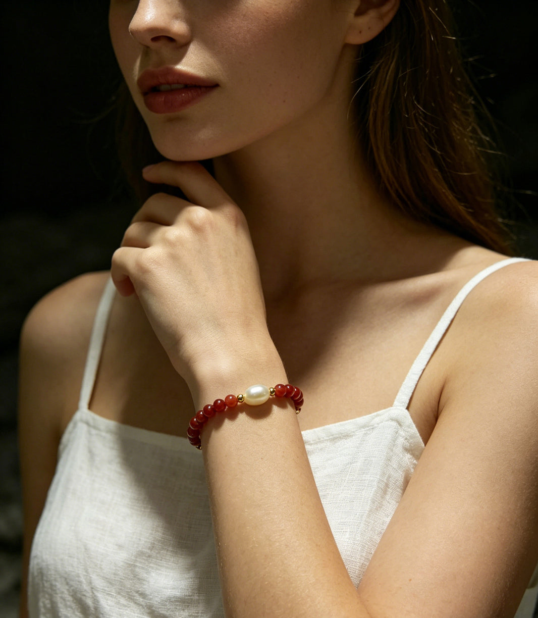 Ember red bead and baroque pearl stretch bracelet worn view