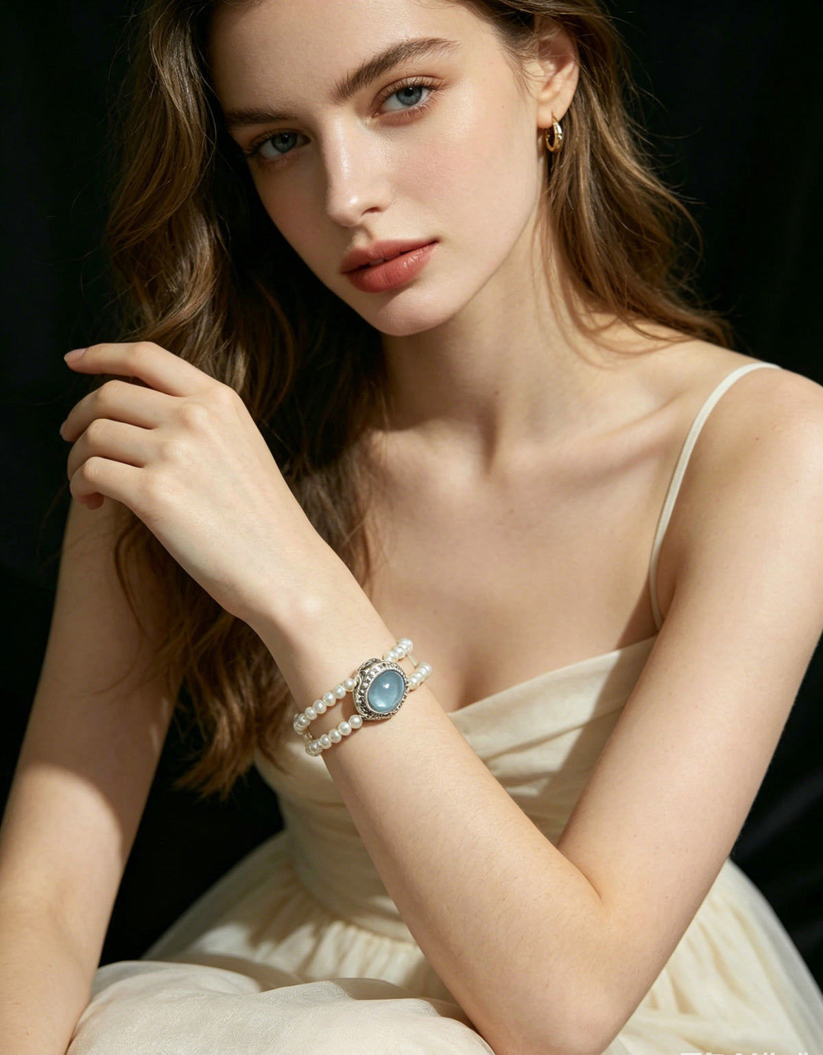 Lagoon white pearl triple-strand blue center bracelet worn view