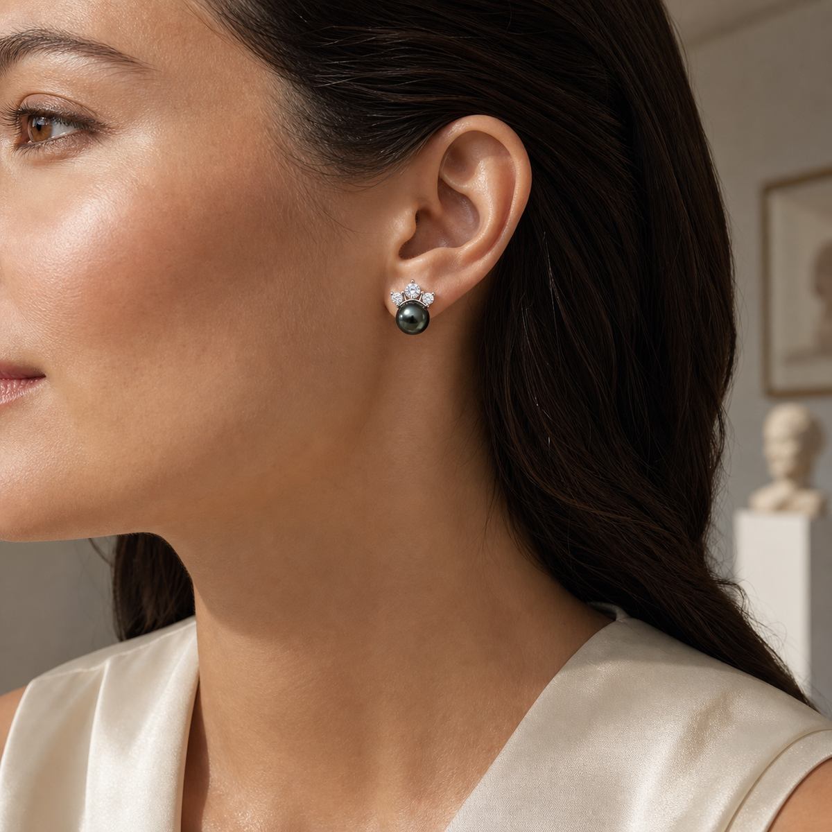 Model wearing Crown Lagoon black Tahitian South Sea pearl cubic zirconia stud earrings
