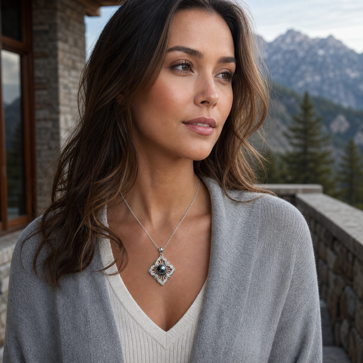 Model wearing Lucky Charm Lagoon black Tahitian South Sea pearl cubic zirconia pendant on a mountain terrace