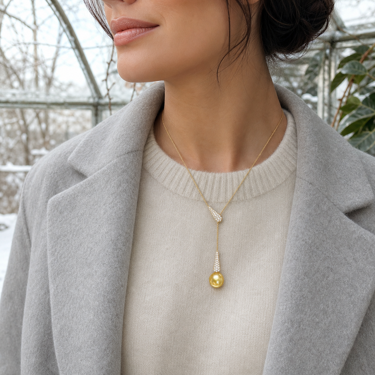Mermaid Golden South Sea pearl pendant worn in a winter conservatory