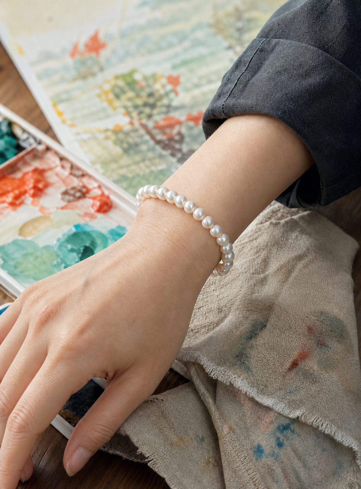 Ripple 6-7mm White Button Freshwater Pearl Stretch Bracelet worn in a lifestyle setting